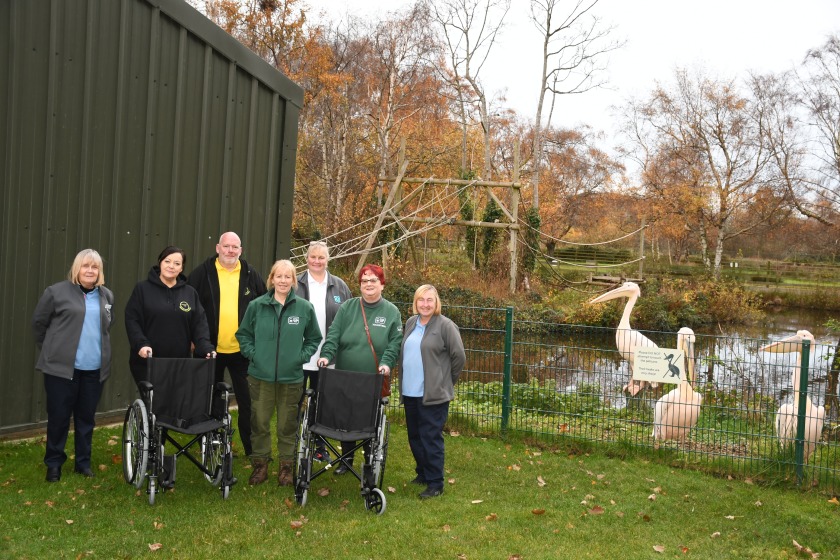 From left to right: Norma Smethurst, Co-op; Sally Fergueson and Nick Wildon, Kissack Care; Kathleen Graham, Curraghs Wildlife Park; Jacqui Heaton, Co-op; Shirley Corlett, SCWP; Sue Icely, Co-op plus donated wheelchairs (and on-looking Great White Pelicans).